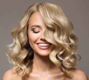 womens blond medium length layered hairstyle curls