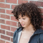 womens mid length layered tight curls hairstyle