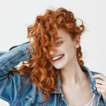 womens layered medium length curly hairstyle red hair
