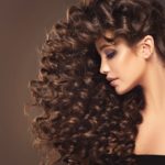 womens long tight curls hairstyle brunette