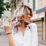 womens shoulder length curly hairstyle with highlights