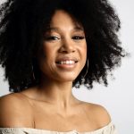 long curly afro hair with curtain bangs