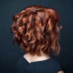women's short curly copper inverted bob hairstyle