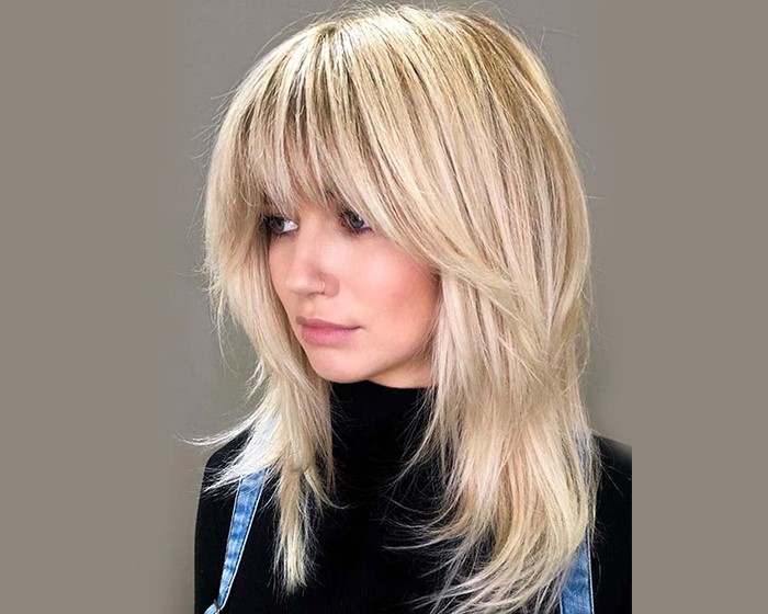 straight layered hair with side swept bangs