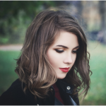 women shoulder length wavy bob haircut with light highlights